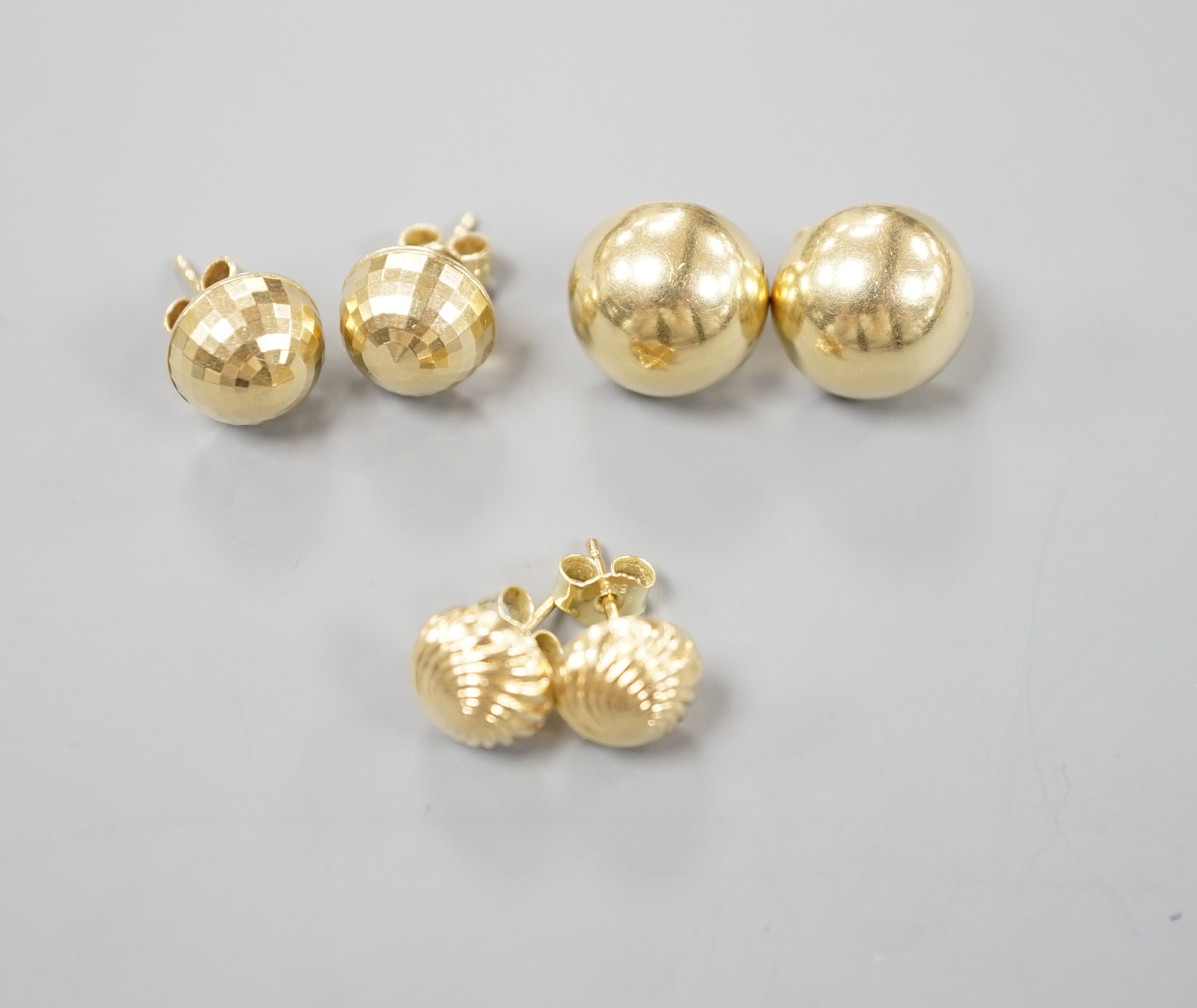 Two modern pairs of 750 yellow metal ear studs, one with 925 butterflies, gross 7.3 grams and a pair of 585 ear studs 2.3 grams.